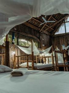 a bedroom with two beds and a tent at Your Zanzibar Place in Paje