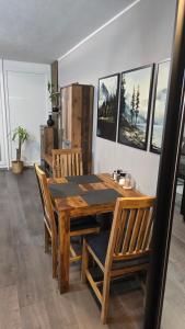 a dining room with a wooden table and chairs at WaldLoft in Todtmoos +17 photos
