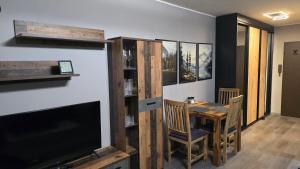 a dining room with a table and a television at WaldLoft in Todtmoos