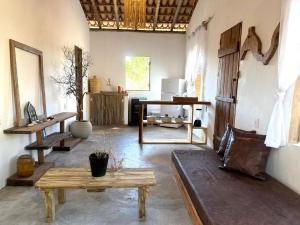 a living room with a table and a couch in it at Anahi Caraiva in Caraíva