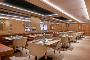 a restaurant with tables and chairs in a room at AC Hotel Atocha by Marriott in Madrid