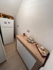 a kitchen with a wooden counter and a refrigerator at Zi Maria in Roccasecca +1 photo