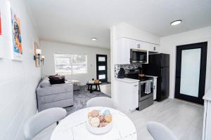 a kitchen and living room with a table and chairs at Close to the Action, Peaceful When You Return in Orlando