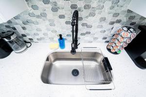 a sink with a faucet in a kitchen at Close to the Action, Peaceful When You Return in Orlando +59 photos