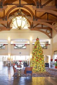 a christmas tree in the lobby of a hotel at Auburn Marriott Opelika Resort & Spa at Grand National in Opelika