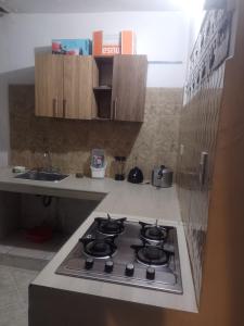 a kitchen with a stove top oven in a kitchen at Apto central 3 hab in Apartadó
