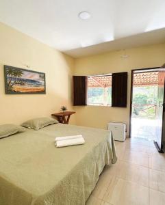 En eller flere senge i et værelse på Pousada Santa terezinha