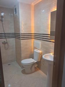 a bathroom with a toilet and a sink at Baya Residentie in Temara +14 photos
