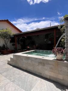 a swimming pool in front of a house at Villas House in Pirenópolis