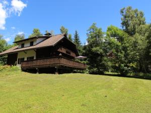 a house sitting on top of a lush green field at Mooshausl in Gnesau