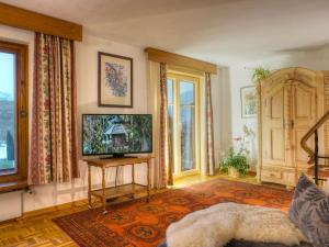 een woonkamer met een flatscreen-tv op een tafel bij I in the Anton house in Obermaiselstein