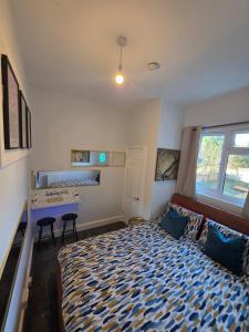 a bedroom with a bed and a desk in it at Aura - 8ight Havens Folkestone in Folkestone