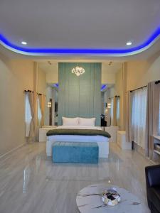 a large bedroom with a bed and a blue ceiling at Tropical Oasis Aoyon Beach House in Ban Ao Makham