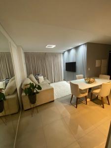 een woonkamer met een tafel en een bank bij Sofisticado, aconchegante e moderno in João Pessoa