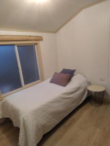 Ένα ή περισσότερα κρεβάτια σε δωμάτιο στο Temporada de verano Puerto Varas