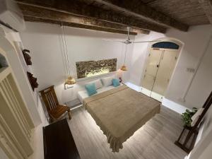 a bedroom with a bed with blue pillows in it at 1929 Sudu Colonial House in Ambalangoda