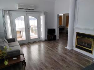 a living room with a couch and a fireplace at Waterfront apartment in Gatineau