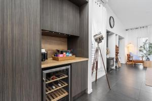 a room with a kitchen with a counter and a camera at Summit to Sea, Elevated Luxury in Coolum Beach