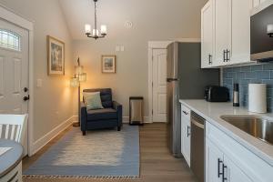 a kitchen with a sink and a chair in it at Ocean Pearl in Kill Devil Hills