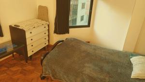 a bedroom with a dresser and a bed and a dresser at super central apartment in La Paz