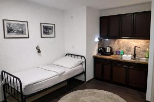 a small room with a bed and a kitchen at Garden Lux Grujić Apartmani in Krivi Vir +35 photos