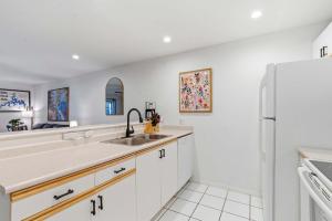 a kitchen with a sink and a refrigerator at Modern Fishing Lodge 8ppl in Branson +15 photos