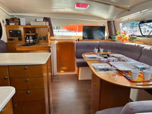 a small kitchen with a table in an rv at Your Private Boat - Magic Bora Bora-FR Polynesia in Bora Bora