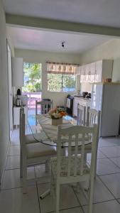 a kitchen and dining room with a table and chairs at Terraço do Sol Apt 03 in Marcelino Ramos