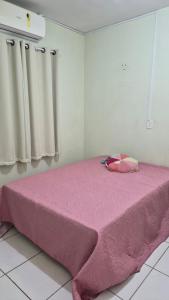 a large pink bed in a room with curtains at Terraço do Sol Apt 03 in Marcelino Ramos
