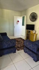 a living room with a couch and a door with a desk at Terraço do Sol Apt 03 in Marcelino Ramos