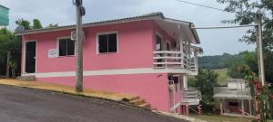 a pink building on the side of a street at Terraço do Sol Apt 03 in Marcelino Ramos