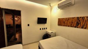 Et tv og/eller underholdning på Casa de Praia com Piscina em Maceió - Ipioca - Sauaçuhy