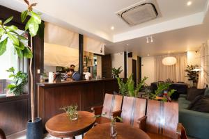 a living room with two tables and a couch at Nap Old Town in Bangkok