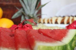 a pile of watermelon slices on a table with other fruit at L Grace Centro in Búzios