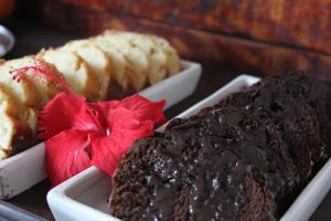 a tray with three different types of cakes and desserts at L Grace Centro in Búzios