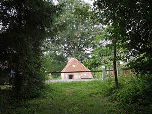 a house in the middle of a field with a fence at Ancien moulin avec terrasse et animaux acceptés - FR-1-497-84 in Marchainville