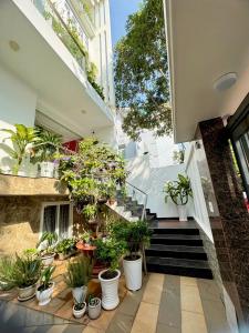 an indoor garden with potted plants on the stairs at Dopamine Hotel in Vung Tau