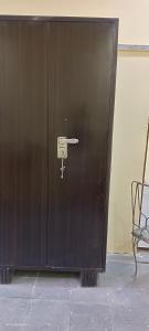 a large wooden door with a key on it at Khans villa in Hyderabad