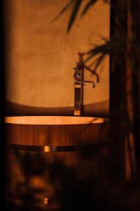 a bathroom sink with a faucet on top of it at One Harajuku: Private Oasis in Tokyo +45 photos