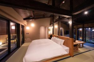 Ένα ή περισσότερα κρεβάτια σε δωμάτιο στο Nazuna Kyoto Higashi Honganji +62 φωτογραφίες