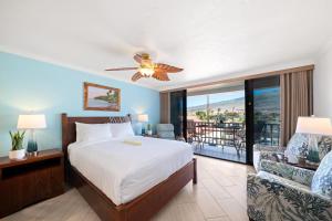 a bedroom with a bed and a balcony at Lahaina Shores 212 in Lahaina +45 photos