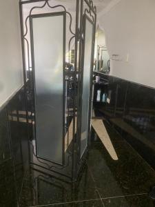 a bathroom with a mirror in a room at Med House in Guaíra