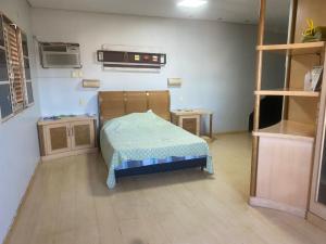 a small room with a bed in a room at Med House in Guaíra +11 photos