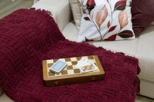 a red blanket with a chess board on a couch at Cherry Douro Hill in Resende