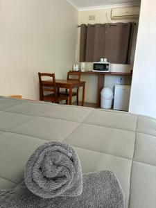 a room with a bed with a towel on it at Wee Waa Motel in Wee Waa +29 photos