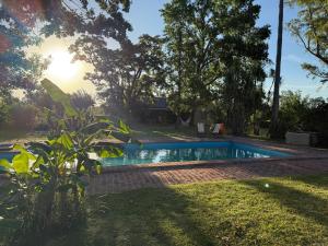 a swimming pool in the yard of a house at La Caballeriza in Mercedes