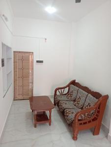 a living room with a couch and a table at SuryaVinayak Home Stay - 10min walk from Railway station in Ghātsīla