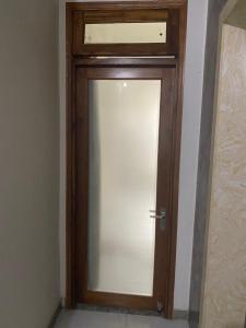 a glass door with a wooden frame in a room at Không có tên in Ho Chi Minh City