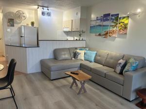 a living room with a couch and a table at ZenCBD, Hidden Gem in Cairns