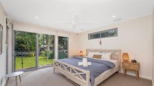 En eller flere senge i et værelse på Coastal Soul - Pearl Beach